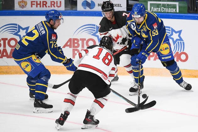 Russia Ice hockey, Eishockey Euro Tour Canada - Sweden 6723749 17.12.2021 From left, Sweden s Tim Heed, Canada s Corban Knight, Canada s Mat Robinson and Sweden s Linus Johansson struggle for a puck during the Channel One Cup match of the Euro Hockey Tour between Canada and Sweden, in Moscow, Russia. Vladimir Astapkovich Sputnik Moscow Russia  Copyright: xVladimirxAstapkovichx