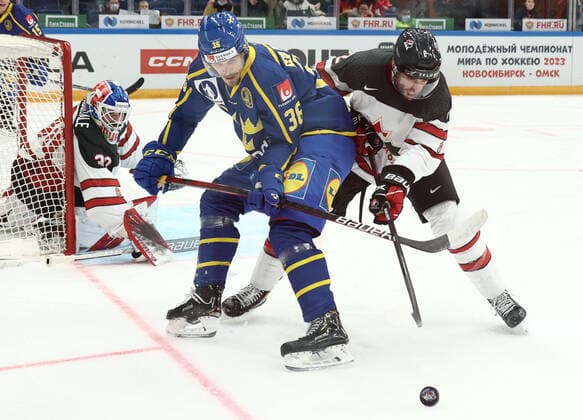 MOSCOW, RUSSIA â€“ DECEMBER 17, 2021: Canadaâ€™s goaltender Edward Pasquale (L) supported by Brandon Gormley (R) defends against Swedenâ€™s Emil Larsson in their national teamsâ€™ 2021 Channel One Cup Ice hockey, Eishockey match at CSKA Arena as part of the 2021 22 Euro Hockey Tour. Valery Sharifulin TASS  TS11C307