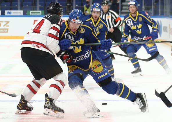 MOSCOW, RUSSIA â€“ DECEMBER 17, 2021: Canadaâ€™s Reece Scarlett and Swedenâ€™s Gustav Rydahl (L-R front) in their national teamsâ€™ 2021 Channel One Cup Ice hockey, Eishockey match at CSKA Arena as part of the 2021 22 Euro Hockey Tour. Valery Sharifulin TASS  TS11C309