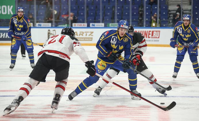 MOSCOW, RUSSIA â€“ DECEMBER 17, 2021: Canadaâ€™s Tyler Graovac and Swedenâ€™s Pontus Holmberg (L-R front) in their national teamsâ€™ 2021 Channel One Cup Ice hockey, Eishockey match at CSKA Arena as part of the 2021 22 Euro Hockey Tour. Valery Sharifulin TASS  TS11C30B