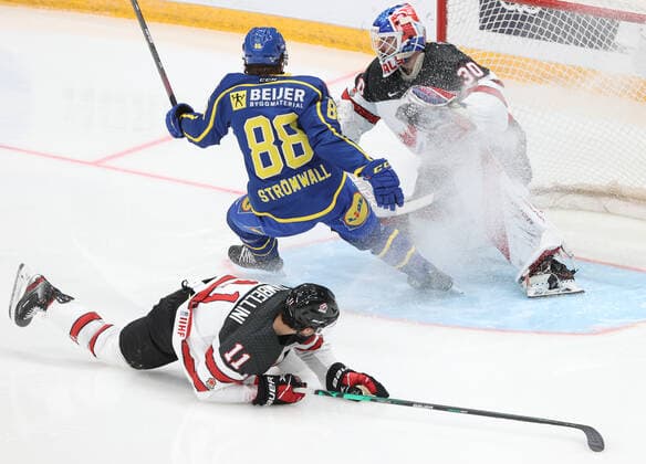 MOSCOW, RUSSIA â€“ DECEMBER 17, 2021: Canadaâ€™s goaltender Edward Pasquale (R back) supported by Adam Tambellini (front) defends against Swedenâ€™s Malte Stromwall in their national teamsâ€™ 2021 Channel One Cup Ice hockey, Eishockey match at CSKA Arena as part of the 2021 22 Euro Hockey Tour. Valery Sharifulin TASS  TS11C346