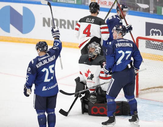 MOSCOW, RUSSIA â€“ DECEMBER 18, 2021: Finland s Jere Karjalainen (L front) and Juuso Parssinen (R front) celebrate as Canada s Justing Pogge (C front) concedes a goal in their national teams 2021 Channel One Cup Ice hockey, Eishockey match at CSKA Arena as part of the 2021 22 Euro Hockey Tour. Mikhail Japaridze TASS  TS11C467