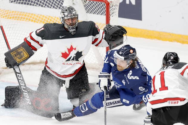 MOSCOW, RUSSIA â€“ DECEMBER 18, 2021: Canadaâ€™s goaltender Justin Pogge (L) defends against Finlandâ€™s Markus Granlund in their national teamsâ€™ 2021 Channel One Cup Ice hockey, Eishockey match at CSKA Arena as part of the 2021 22 Euro Hockey Tour. Mikhail Japaridze TASS  TS11C46F