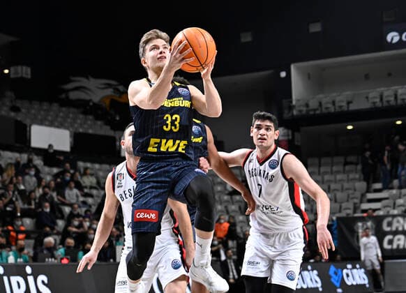 Furkan Haltali (R) of Besiktas Icrypex and Bennet Hundt (33) of Ewe Baskets Oldenburg during the FIBA Champions League group H match between Besiktas Icrypex and Ewe Baskets Oldenburg at Besiktas Akatlar Arena in Istanbul , Turkey on December 21 , 2021. ( Photo by Seskimphoto ) 