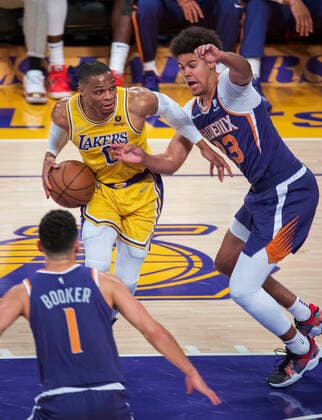 December 21, 2021, Los Angeles, California, USA: Russell Westbrook 0 of the Los Angeles Lakers is defended by Cameron Johnson 23 of the Phoenix Suns during their NBA, Basketball Herren, USA game on Tuesday December 21, 2021 at the Staples Center in Los Angeles, California. Lakers lose to Suns, 90-108. PI Los Angeles USA - ZUMAp124 20211221_zaa_p124_008 Copyright: xJAVIERxROJASx
