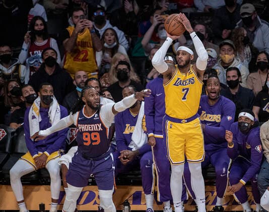 December 21, 2021, Los Angeles, California, USA: Camelo Anthony 7 of the Los Angeles Lakers puts a shot past Jae Crowder 99 of the Phoenix Suns during their NBA, Basketball Herren, USA game on Tuesday December 21, 2021 at the Staples Center in Los Angeles, California. Lakers lose to Suns, 90-108. PI Los Angeles USA - ZUMAp124 20211221_zaa_p124_022 Copyright: xJAVIERxROJASx