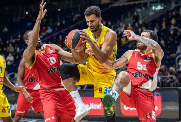 Basketball EuroLeague, ALBA Berlin AS Monaco, Matchday 17, Mercedes Benz Arena ALBAs Johannes Thiemann M fights for the ball against Mike James r and Will Thomas of AS Monaco ALBA Berlin AS Monaco