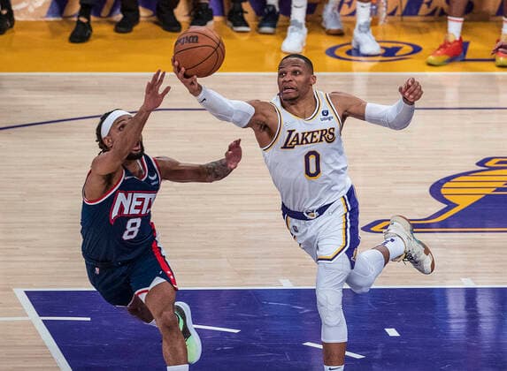 December 25, 2021, Los Angeles, California, USA: Russell Westbrook 0 of the Los Angeles Lakers gets a rebound from Patty Mills 8 of the Brooklyn Nets during their NBA, Basketball Herren, USA home game on Saturday December 25, 2021 at Crypto.com Arena in Los Angeles, California. Lakers lose to Nets, 115-122. PI Los Angeles USA - ZUMAp124 20211225_zaa_p124_013 Copyright: xJAVIERxROJASx
