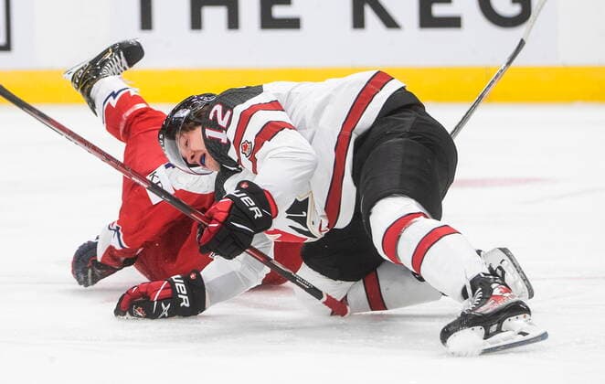 December 26, 2021, EDMONTON, AB, CANADA: Canada s Jake Neighbours (12) is tripped up by a Czech Republic player during first period IIHF World Junior Hockey Championship action in Edmonton on Sunday, December 26, 2021. Jake Neighbours  - ZUMAc35_ 20211226_zaf_c35_082 Copyright: xJasonxFransonx