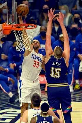 LOS ANGELES, CA - DECEMBER 26: Los Angeles Clippers forward Nicolas Batum (33) gets past Denver Nuggets center Nikola Jokic (15) for a dunk in the first half of an NBA, Basketball Herren, USA game on December 26, 2021, at Crypto.com Arena in Los Angeles, CA. (Photo by John McCoy Icon Sportswire) NBA: DEC 26 Nuggets at Clippers Icon2112260478