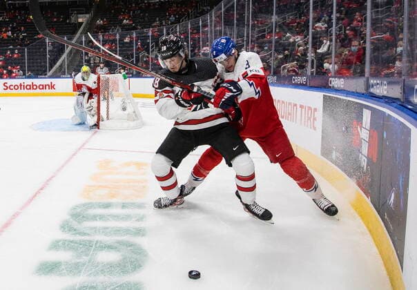 December 26, 2021, EDMONTON, AB, CANADA: Canada s Xavier Bourgault (18) and Czech Republic s David Spacek (3) battle for the puck during third period IIHF World Junior Hockey Championship action in Edmonton on Sunday, December 26, 2021. Xavier Bourgault David Spacek  - ZUMAc35_ 20211226_zaf_c35_096 Copyright: xJasonxFransonx