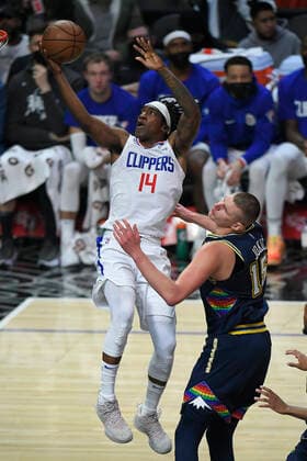 LOS ANGELES, CA - DECEMBER 26: Los Angeles Clippers guard Terance Mann (14) gets past Denver Nuggets center Nikola Jokic (15) for a basket in the first half of an NBA, Basketball Herren, USA game on December 26, 2021, at Crypto.com Arena in Los Angeles, CA. (Photo by John McCoy Icon Sportswire) NBA: DEC 26 Nuggets at Clippers Icon2112261081