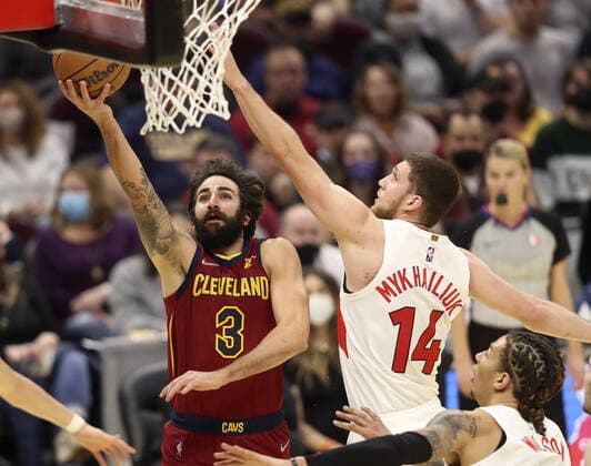 Cleveland Cavaliers Ricky Rubio (3) scores past Toronto Raptors JSvi Mykhailiuk (14) at Rocket Mortgage FieldHouse in Cleveland, Ohio on Sunday, December 26, 2021.  CLE20211226113 AARONxJOSEFCZYK