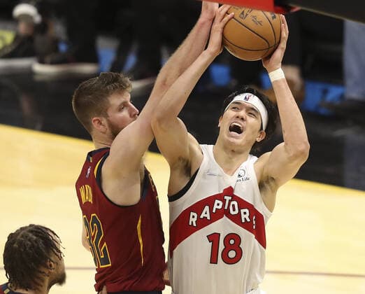Toronto Raptors Yuta Watanabe (18) is fouled by Cleveland Cavaliers Dean Wade (32) at Rocket Mortgage FieldHouse in Cleveland, Ohio on Sunday, December 26, 2021.  CLE20211226114 AARONxJOSEFCZYK