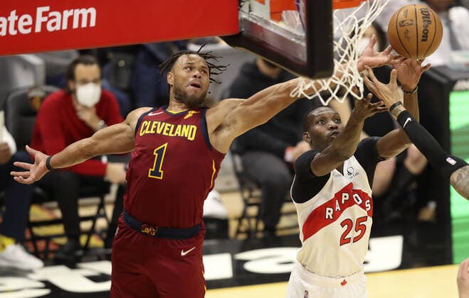 Cleveland Cavaliers Justin Anderson (1) reaches for a rebound over Toronto Raptors Chris Boucher (25) at Rocket Mortgage FieldHouse in Cleveland, Ohio on Sunday, December 26, 2021.  CLE20211226116 AARONxJOSEFCZYK