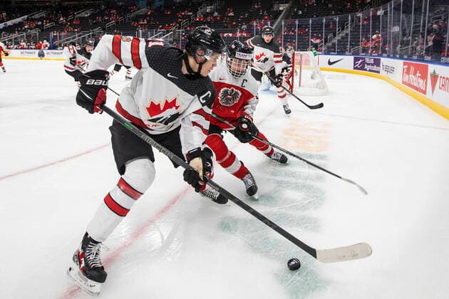 December 28, 2021, EDMONTON, AB, CANADA: Canada s Kaiden Guhle (21) and Austria s Marco Kasper (19) battle for the puck during first period IIHF World Junior Hockey Championship action in Edmonton on Tuesday, December 28, 2021. Kaiden Guhle Marco Kasper  - ZUMAc35_ 20211228_zaf_c35_056 Copyright: xJasonxFransonx