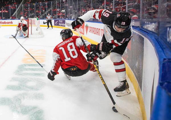 December 28, 2021, EDMONTON, AB, CANADA: Canada s Elliot Desnoyers (19) checks Austria s Martin Urbanek (18) during second period IIHF World Junior Hockey Championship action in Edmonton on Tuesday, December 28, 2021. Elliot Desnoyers Martin Urbanek  - ZUMAc35_ 20211228_zaf_c35_075 Copyright: xJasonxFransonx