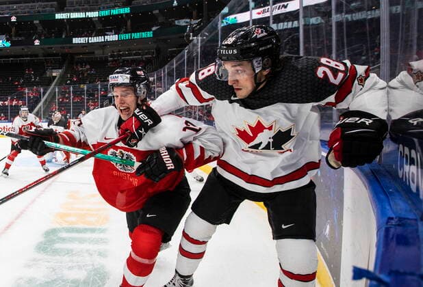 December 28, 2021, EDMONTON, AB, CANADA: Canada s Ryan ORourke (28) and Austria s Senna Peeters (17) battle for the puck during third period IIHF World Junior Hockey Championship action in Edmonton on Tuesday, December 28, 2021. Ryan OÕRourke Senna Peeters  - ZUMAc35_ 20211228_zaf_c35_091 Copyright: xJasonxFransonx