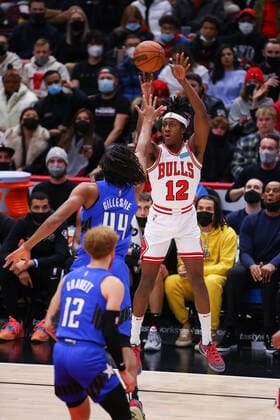 CHICAGO, IL - JANUARY 03: Chicago Bulls Guard Ayo Dosunmu (12) shoots a three point basket during a NBA, Basketball Herren, USA game between the Orlando Magic and the Chicago Bulls on January 3, 2022 at the United Center in Chicago, IL. (Photo by Melissa Tamez Icon Sportswire) NBA: JAN 03 Magic at Bulls Icon22010321