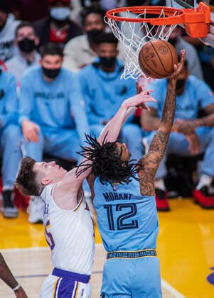 January 9, 2022, Los Angeles, California, USA: Austin Reaves 15 of the Los Angeles Lakers tries to block a shot by Ja Morant 12 of the Memphis Grizzlies during their NBA, Basketball Herren, USA game on Sunday January 9, 2022 at Crypto.com Arena in Los Angeles, California. PI Los Angeles USA - ZUMAp124 20220109_zaa_p124_036 Copyright: xJAVIERxROJASx