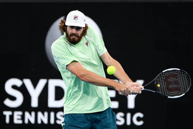 SYDNEY, AUSTRALIA - JANUARY 14: Reilly Opelka of USA plays a backhand during the Sydney Classic Tennis match between Andy Murray of Great Britain and Reilly Opelka of USA at Ken Rosewall Arena on January 14, 2022 in Sydney, Australia. (Photo by Steven Markham Icon Sportswire) TENNIS: JAN 14 Sydney Classic Icon2201140057