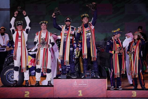 Chilean driver Francisco Chaleco Lopez (C-1st), Swedish driver Sebastian Eriksson (L-2nd) and Spanish driver Cristina Gutierrez (3-rd) celebrate on the podium of the lightweight prototypes category after the 12ª and last stage of the Dakar rally, in Jeddah, Saudi Arabia, 14 January 2021. 12ª and last stage of Dakar rally !ACHTUNG: NUR REDAKTIONELLE NUTZUNG!  Copyright: xBielxAlinox GRAF9948 20220114-37f15f1a5919ae45351c26c15ec92163e8ee1922