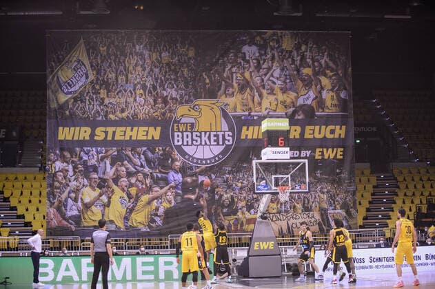 A poster with photos of spectators at the match EWE Baskets Oldenburg vs MHP Riesen Ludwigsburg Basketball, easyCredit BBL, season 2021 2022, 16 matchday, 15 01 2022 Copyright xErikxHillmer EIBNERx EP EHR EWE Baskets Oldenburg vs MHP Riesen Ludwigsburg Basketball, easyCredit BBL, season 2021 2022, 16 matchday, 15 01 2022 Oldenburg Copyright: xErikxHillmer EIBNERx EP_EHR