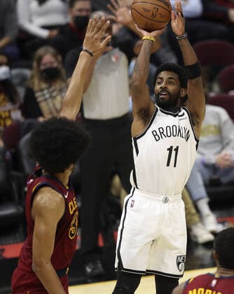 Brooklyn Nets Kyrie Irving (11) shoots over Cleveland Cavaliers Jarrett Allen (31) at Rocket Mortgage Field House in Cleveland, Ohio on Monday, January 17, 2022.  CLE20220117107 AARONxJOSEFCZYK