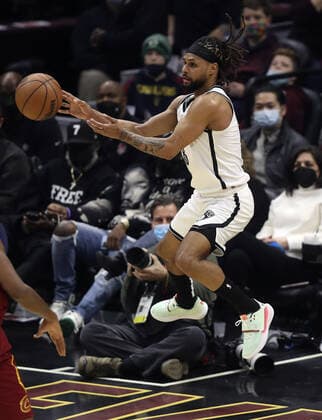 Brooklyn Nets Patty Mills (8) saves a ball from going out of bounds against the Cleveland Cavaliers at Rocket Mortgage Field House in Cleveland, Ohio on Monday, January 17, 2022.  CLE20220117114 AARONxJOSEFCZYK