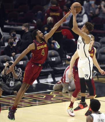 Cleveland Cavaliers Evan Mobley (4) blocks the shot of Brooklyn Nets Kessler Edwards (14) at Rocket Mortgage Field House in Cleveland, Ohio on Monday, January 17, 2022.  CLE20220117121 AARONxJOSEFCZYK