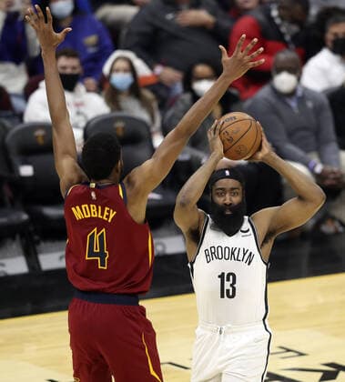Brooklyn Nets James Harden (13) looks to make a pass past Cleveland Cavaliers Evan Mobley (4) at Rocket Mortgage Field House in Cleveland, Ohio on Monday, January 17, 2022.  CLE20220117127 AARONxJOSEFCZYK
