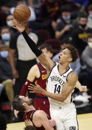 Brooklyn Nets Kessler Edwards (14) is called for a charge on Cleveland Cavaliers Kevin Love (0) at Rocket Mortgage Field House in Cleveland, Ohio on Monday, January 17, 2022.  CLE20220117110 AARONxJOSEFCZYK