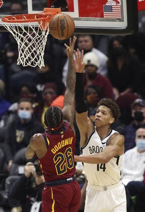 Brooklyn Nets Kessler Edwards (14) attempts to block the shot of Cleveland Cavaliers Brandon Goodwin (26) at Rocket Mortgage Field House in Cleveland, Ohio on Monday, January 17, 2022.  CLE20220117111 AARONxJOSEFCZYK