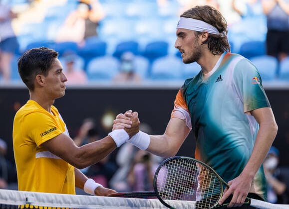 (220120) -- MELBOURNE, Jan. 20, 2022 -- Sebastian Baez (L) of Argentina shakes hands with Stefanos Tsitsipas of Greece after their men s singles 2nd round match at Australian Open in Melbourne Park, in Melbourne, Australia, Jan. 20, 2022. (Photo by Xinhua) (SP)AUSTRALIA-MELBOURNE-TENNIS-AUSTRALIAN OPEN-MEN S SINGLES HuxJingchen 