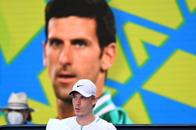 Mandatory Credit: Photo by James Gourley Shutterstock (12765086fl) Denis Shapovalov sitting in front of an image of Novak Djokovic during his third round match Australian Open, Day Five, Tennis, Melbourne Park, Melbourne, Australia - 21 Jan 2022 Australian Open, Day Five, Tennis, Melbourne Park, Melbourne, Australia - 21 Jan 2022 Copyright: xJamesxGourley Shutterstockx 12765086fl