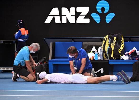 Mandatory Credit: Photo by James Gourley Shutterstock (12765100di) Maxime Cressy receiving treatment during his fourth round match Australian Open, Day Eight, Tennis, Melbourne Park, Melbourne, Australia - 24 Jan 2022 Australian Open, Day Eight, Tennis, Melbourne Park, Melbourne, Australia - 24 Jan 2022 Copyright: xJamesxGourley Shutterstockx 12765100di