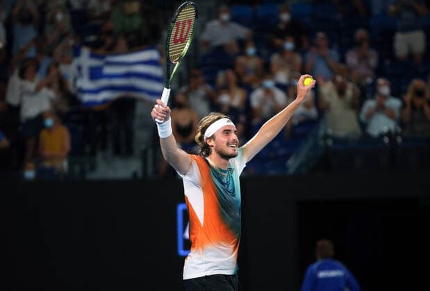 Mandatory Credit: Photo by Ella Ling Shutterstock (12765099fe) Stefanos Tsitsipas celebrates in front of a Greek flag after victory in his fourth round match Australian Open, Day Eight, Tennis, Melbourne Park, Melbourne, Australia - 24 Jan 2022 Australian Open, Day Eight, Tennis, Melbourne Park, Melbourne, Australia - 24 Jan 2022 Copyright: xEllaxLing Shutterstockx 12765099fe