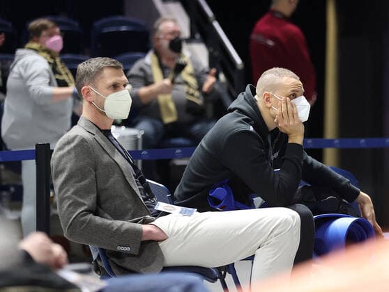 Nils Mittmann and the injured Robin Amaize Basketball Loewen Braunschweig