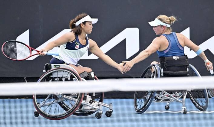 Tennis: Australian Open Yui Kamiji (L) of Japan low-fives Lucy Shuker (L) of Britain after winning a point during the women s wheelchair doubles final against Diede De Groot and Aniek Van Koot of the Netherlands at the Australian Open tennis tournament in Melbourne on Jan. 26, 2022.  A14AA0001206587P