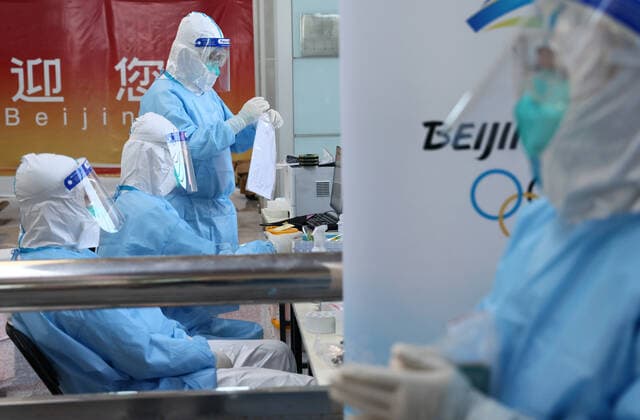 BEIJING, CHINA - JANUARY 28, 2022: Employees are seen while people undergo PCR tests for COVID-19 upon their arrival at Beijing Capital International Airport ahead of the 2022 Winter Olympics. The 24th Winter Olympic Games, Olympische Spiele, Olympia, OS are scheduled to take place in Beijing on February 4-20, 2022. Valery Sharifulin TASS  0149073407st