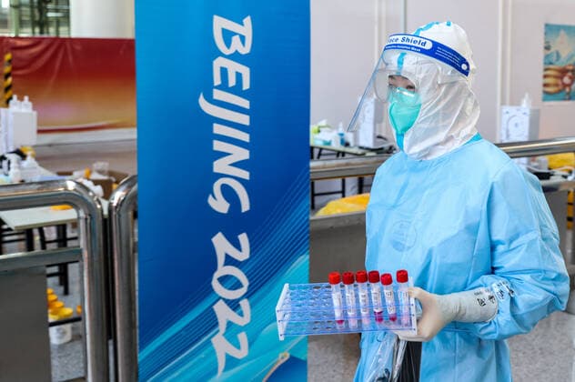 BEIJING, CHINA - JANUARY 28, 2022: An employee carries test tubes at a COVID-19 testing area of Beijing Capital International Airport ahead of the 2022 Winter Olympics. The 24th Winter Olympic Games, Olympische Spiele, Olympia, OS are scheduled to take place in Beijing on February 4-20, 2022. Sergei Bobylev TASS  TS1206C3