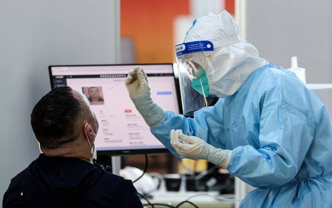 BEIJING, CHINA - JANUARY 28, 2022: A man undergoes a PCR test for COVID-19 upon his arrival at Beijing Capital International Airport ahead of the 2022 Winter Olympics. The 24th Winter Olympic Games, Olympische Spiele, Olympia, OS are scheduled to take place in Beijing on February 4-20, 2022. Sergei Bobylev TASS  TS1206C6