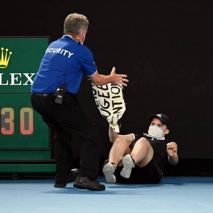 Mandatory Credit: Photo by James Gourley Shutterstock (12778011dj) A court invader is tackled by security and police during the Men s Singles final Australian Open, Day Fourteen, Tennis, Melbourne Park, Melbourne, Australia - 30 Jan 2022 Australian Open, Day Fourteen, Tennis, Melbourne Park, Melbourne, Australia - 30 Jan 2022 Copyright: xJamesxGourley Shutterstockx 12778011dj