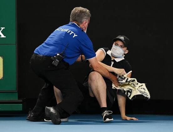 Mandatory Credit: Photo by James Gourley Shutterstock (12778011dh) A court invader is tackled by security and police during the Men s Singles final Australian Open, Day Fourteen, Tennis, Melbourne Park, Melbourne, Australia - 30 Jan 2022 Australian Open, Day Fourteen, Tennis, Melbourne Park, Melbourne, Australia - 30 Jan 2022 Copyright: xJamesxGourley Shutterstockx 12778011dh