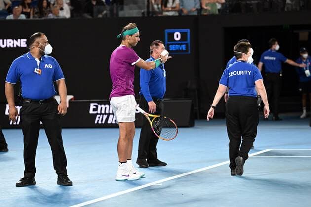 Mandatory Credit: Photo by James Gourley Shutterstock (12778011dl) Rafael Nadal is surrounded by security as a protester is tackled by security and police during the Men s Singles final Australian Open, Day Fourteen, Tennis, Melbourne Park, Melbourne, Australia - 30 Jan 2022 Australian Open, Day Fourteen, Tennis, Melbourne Park, Melbourne, Australia - 30 Jan 2022 Copyright: xJamesxGourley Shutterstockx 12778011dl