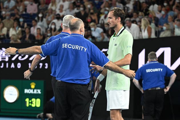 TENNIS AUSTRALIAN OPEN, Daniil Medvedev of Russia is surrounded by security after a protester jumped onto the court during the men?s singles final against Daniil Medvedev of Russia on Day 14 of the Australian Open at Melbourne Park in Melbourne, Sunday, January 30, 2022. ( NO ARCHIVING, EDITORIAL USE ONLY, NO USE IN BOOKS WITHOUT CONSENT MELBOURNE VIC AUSTRALIA  Copyright: xDAVExHUNTx 20220130001618418646