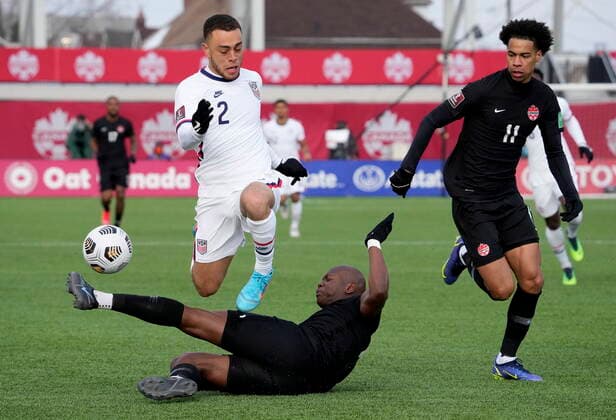 January 30, 2022, Hamilton, ON, CANADA: Canada s Kamal Miller (4) makes the tackle on United States Sergino Dest (2) as Canada s Tajon Buchanan (11) looks on during first half World Cup qualifying soccer action in Hamilton, Ont., Sunday, Jan. 30, 2022. Canada News - January 30, 2022  - ZUMAc35_ 20220130_zaf_c35_047 Copyright: xFrankxGunnx