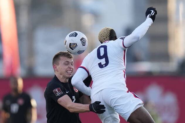 January 30, 2022, Hamilton, ON, CANADA: Canada s Alistair Johnston, left, battles USA s Gyasi Zardes for the ball during second half men s World Cup Qualifier at sold out Tim Hortons Field in Hamilton, Ontario Sunday Jan. 30, 2022. Canada News - January 30, 2022  - ZUMAc35_ 20220130_zaf_c35_065 Copyright: xNathanxDenettex