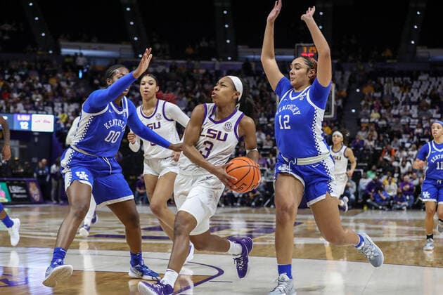 January 30, 2022: LSU s Khayla Pointer (3) dribbles between Kentucky defender s Olivia Owens (00) and Treasure Hunt (12) during NCAA, College League, USA Women s Basketball action between the Kentucky Wildcats and the LSU Tigers at the Pete Maravich Assembly Center in Baton Rouge, LA. CSM Baton Rouge USA - ZUMAc04_ 20220130_zaf_c04_107 Copyright: xJonathanxMailhesx
