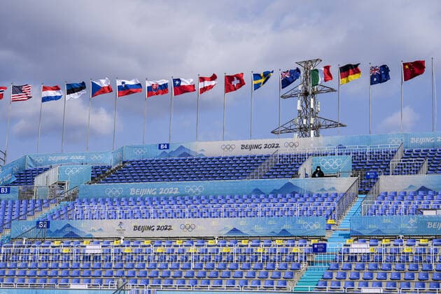 A lone security guard stands amongst empty seating at the Big Air Shougang venue which will host the big air events at the Beijing 2022 Winter Olympics on Monday, January 31, 2022.  OLY20220131299 PaulxHanna
